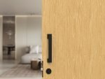 Entrance pull handle with self latching single cylinder lock bundle in matte black finish